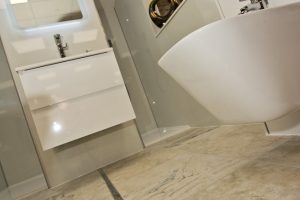 Marbled floor close up of bathroom display by Ocean Bathrooms By Design in Salisbury