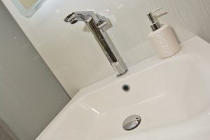 White units and marbled floor Display 3 by Ocean Bathrooms By Design showroom picture in Salisbury Wiltshire
