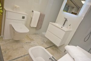 White units and marbled floor Display 1 by Ocean Bathrooms By Design showroom picture in Salisbury Wiltshire