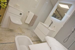 White units and marbled floor Display by Ocean Bathrooms By Design showroom picture in Salisbury Wiltshire