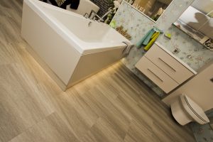 Cream bath panel exhibit by Ocean Bathrooms By Design showroom picture in Salisbury Wiltshire