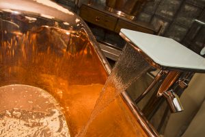 Tap water running inside Copper bath from Ocean Bathrooms By Design in Salisbury
