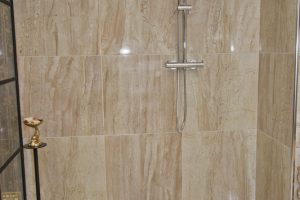 Shower with marble walls from Ocean Bathrooms By Design in Salisbury