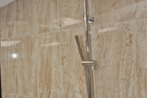 Shower with marble walls from Ocean Bathrooms By Design in Salisbury
