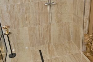 Shower with marble walls from Ocean Bathrooms By Design in Salisbury