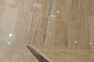 Shower with marble walls from Ocean Bathrooms By Design in Salisbury