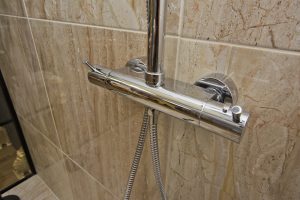 Shower with marble walls from Ocean Bathrooms By Design in Salisbury