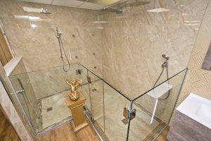 Contemporary shower unit with marble wall from Ocean Bathrooms By Design in Salisbury