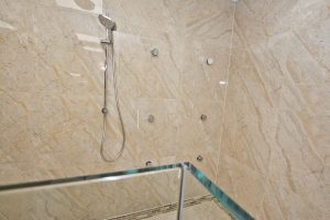 Contemporary shower unit with marble wall from Ocean Bathrooms By Design in Salisbury
