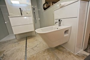 Toilet over marbled floor and basin display 2 by Ocean Bathrooms By Design in Salisbury