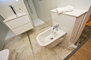 Toilet over marbled floor and basin display by Ocean Bathrooms By Design in Salisbury